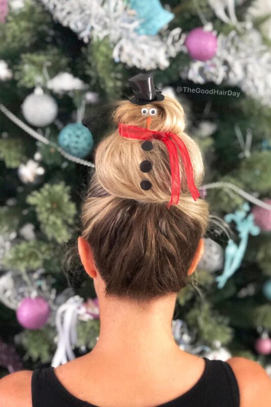 Woman with a snowman-themed bun updo.