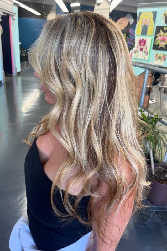 Woman with toasted coconut hair color.