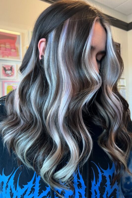 Woman with white peekaboo highlights on her black hair.