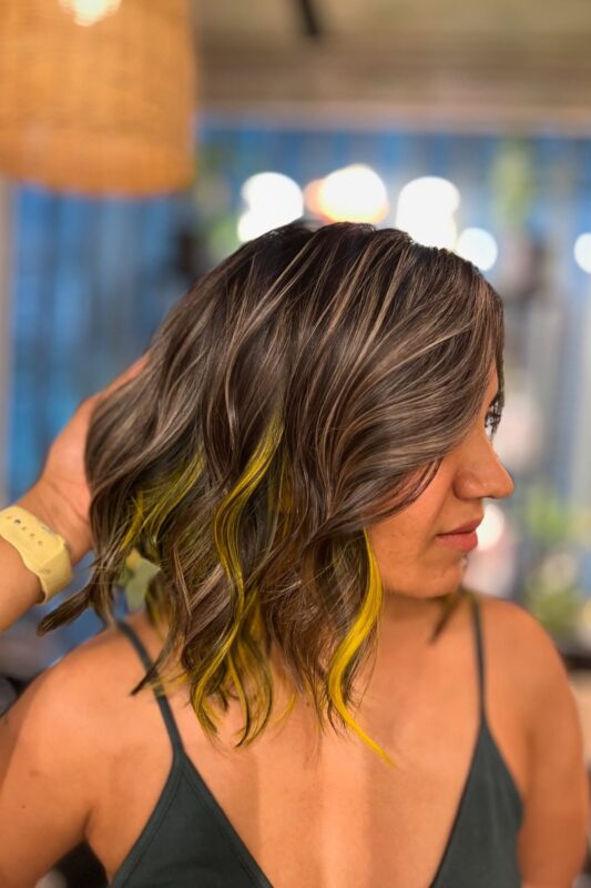 Woman with yellow peekaboo hair.