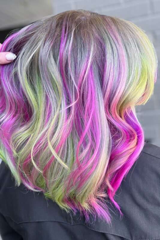 Woman with Barbie pink and Mountain Dew green highlights.