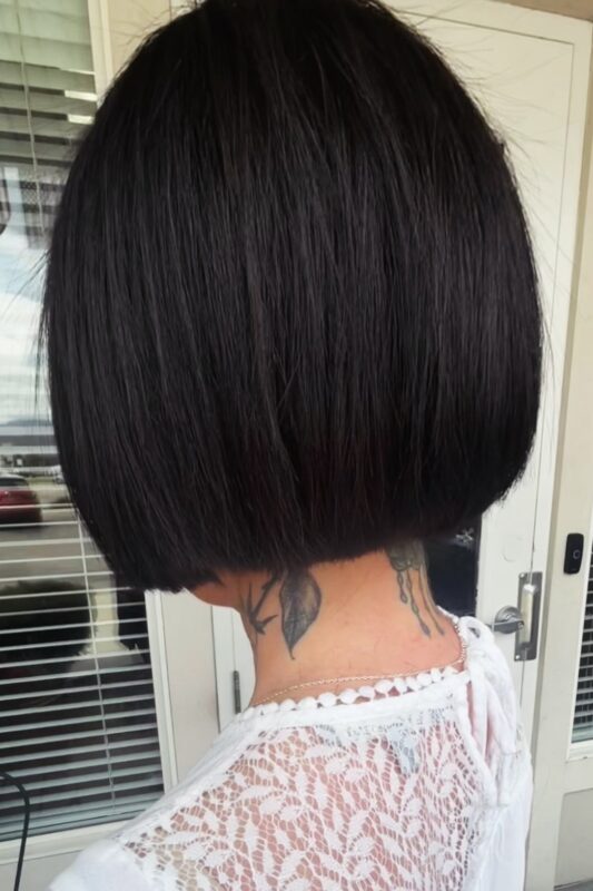 Woman with a blunt French bob with concave layers.