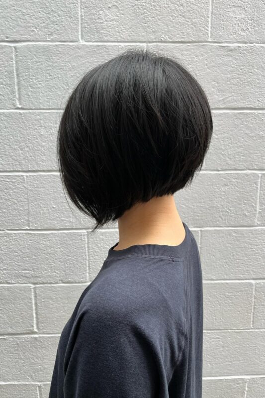 Woman with a chin-length asymmetrical bob haircut.