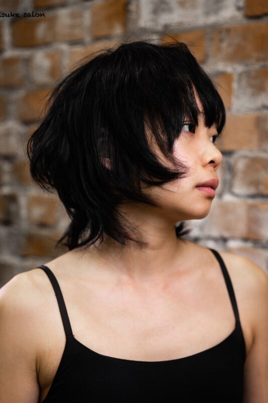 Woman with a chin-length wolf-cut bob haircut.