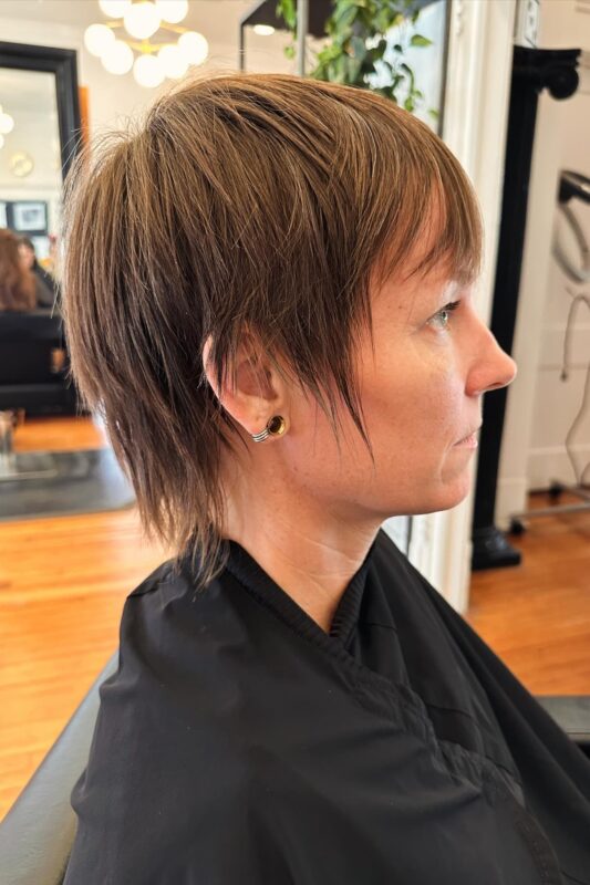 Woman with a choppy pixie cut ideal for fine hair.