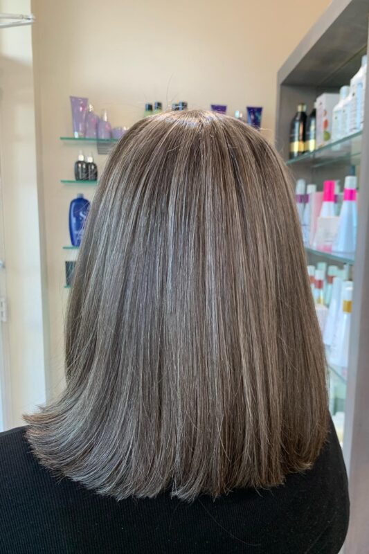 Dark hair with silver herringbone highlights for gray blending.