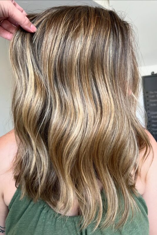 Woman with a dark honey blonde highlights.