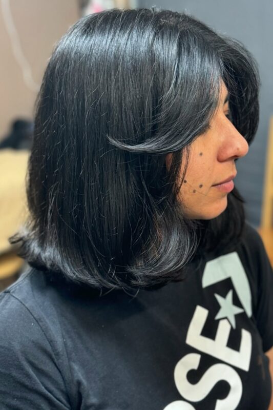 Woman with a shoulder-length bob perfect for fine hair.