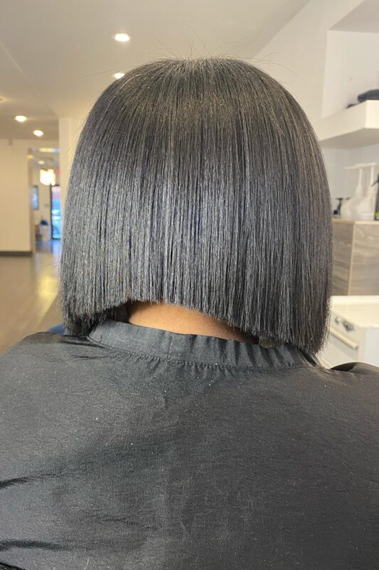 Woman with a French bob haircut and concave layers.