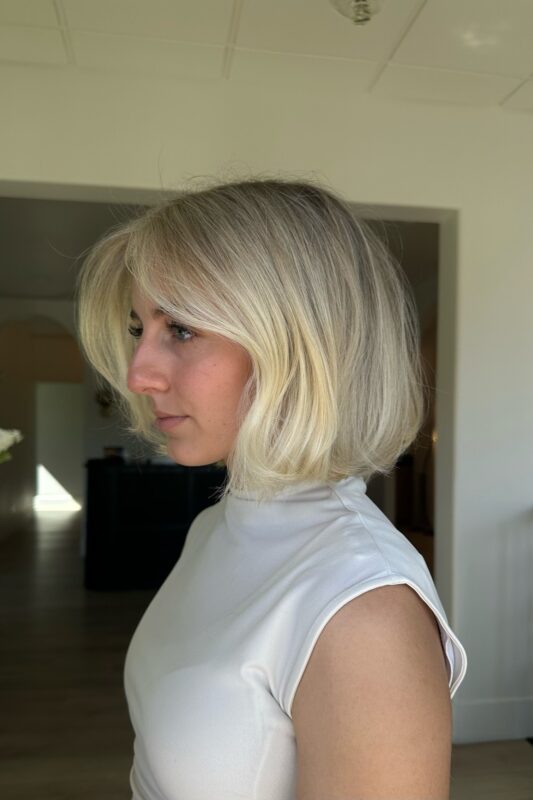 Woman with a French bob featuring face-framing layers.