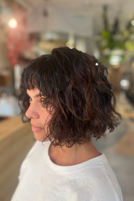 Woman with a French bob cut in layers.