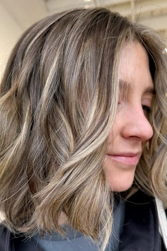 Woman with a messy bob tailored for fine hair.