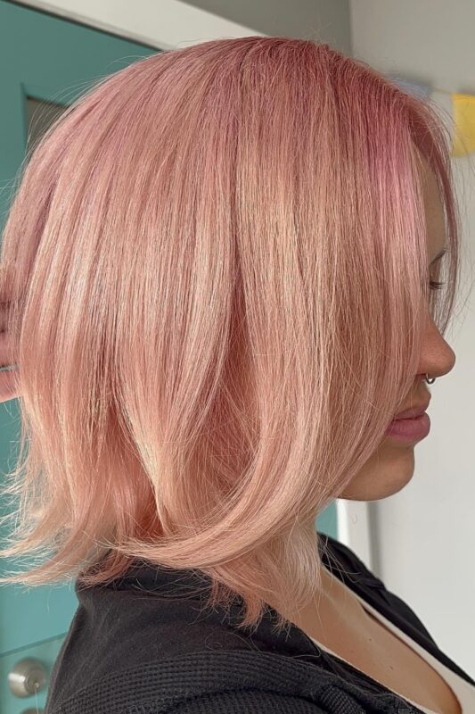 Woman with a rose gold blonde hair color.