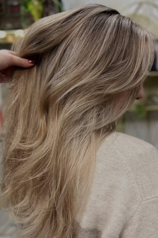 Woman with a sandy blonde hair color.