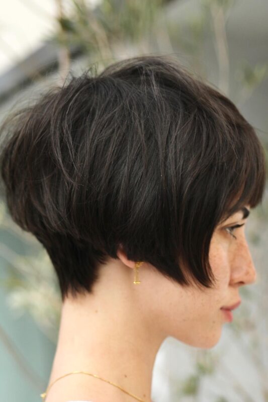 Woman with a super short French bob haircut.