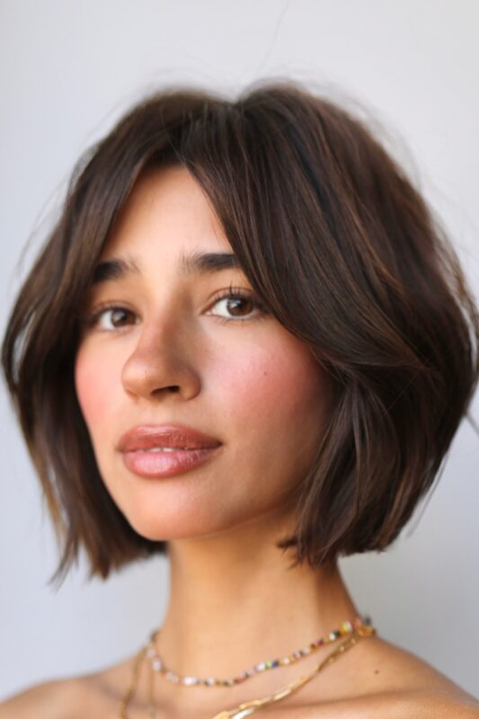 Woman with a tapered, layered French bob hairstyle.