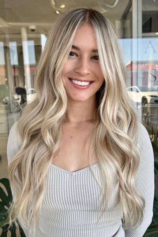 Woman with a vanilla blonde hair color featuring pearly undertones.